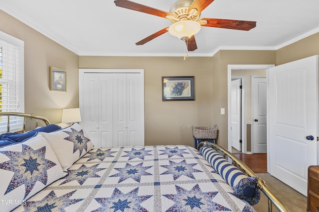 bedroom with a closet, crown molding, and ceiling fan