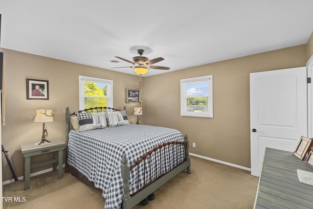 carpeted bedroom featuring baseboards and ceiling fan