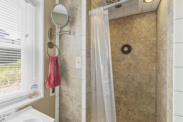 full bathroom featuring a sink and a tile shower