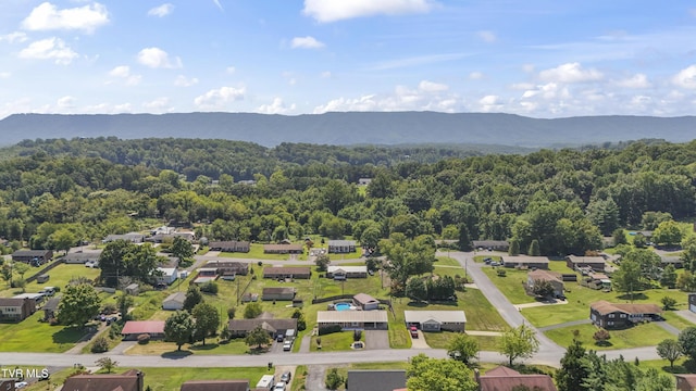 drone / aerial view with a mountain view and a wooded view