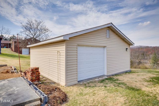 detached garage featuring driveway