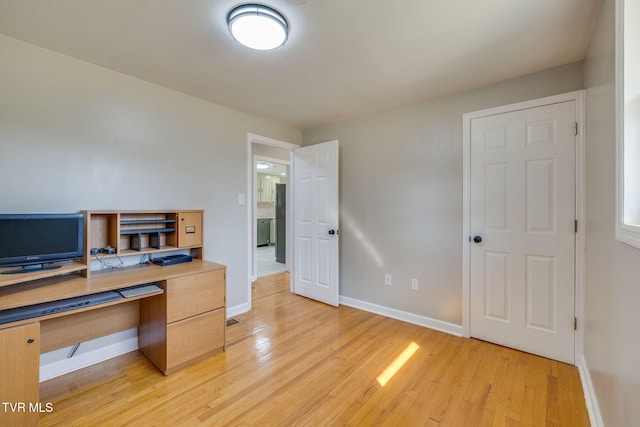 home office featuring baseboards and light wood-style floors
