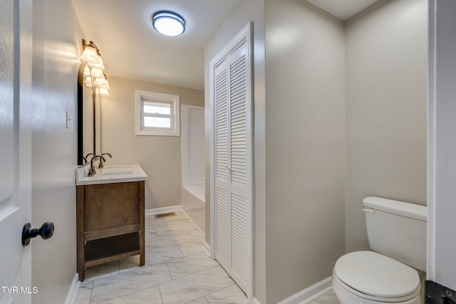bathroom with toilet, marble finish floor, a closet, baseboards, and vanity