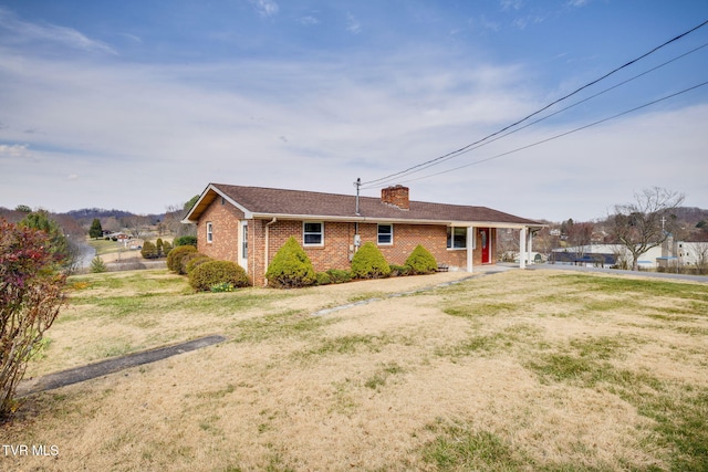 single story home featuring brick siding and a chimney