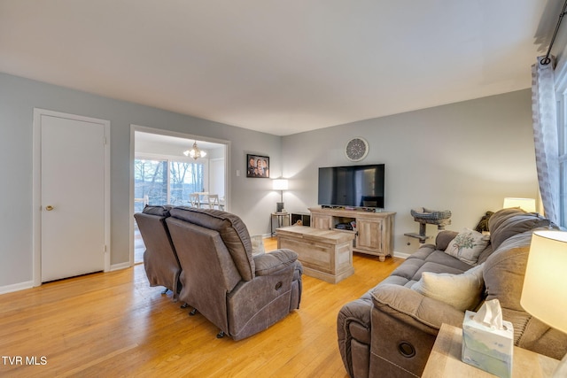 4511 Grace Dr, Kingsport, TN 37664 - living room with baseboards, a notable chandelier, and light wood-style flooring