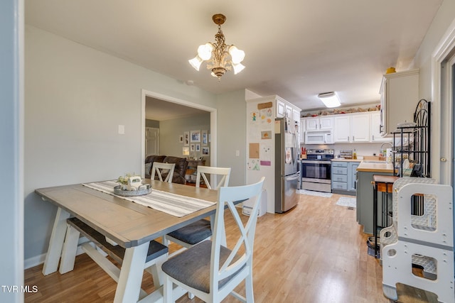4511 Grace Dr, Kingsport, TN 37664 - dining space featuring an inviting chandelier, baseboards, and light wood finished floors