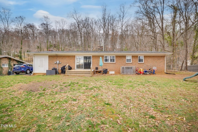 4511 Grace Dr, Kingsport, TN 37664 - rear view of house with brick siding, central air condition unit, and a lawn
