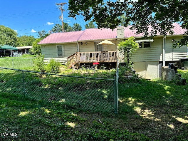 109 Chestnut St, Greeneville, TN 37745 - rear view of house with a chimney, metal roof, a fenced backyard, a deck, and a yard