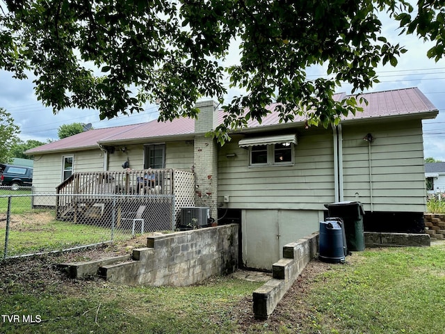 109 Chestnut St, Greeneville, TN 37745 - rear view of house featuring a lawn, central AC unit, a chimney, and fence