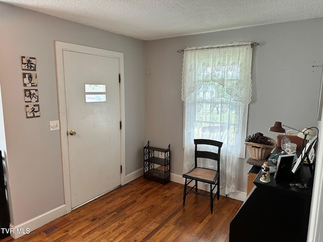 109 Chestnut St, Greeneville, TN 37745 - entryway with visible vents, wood finished floors, baseboards, and a textured ceiling