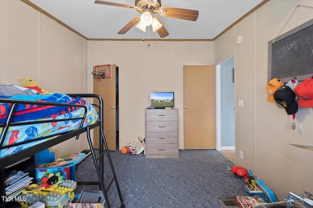 carpeted bedroom featuring a textured ceiling, crown molding, and a ceiling fan