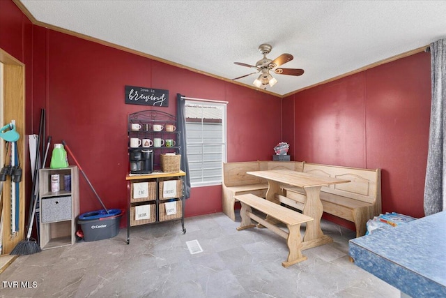 dining room with a textured ceiling and ceiling fan