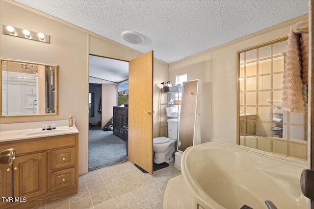 bathroom with a tub, crown molding, toilet, vanity, and a textured ceiling