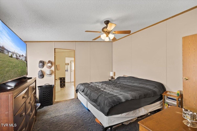 bedroom with carpet flooring, a textured ceiling, a decorative wall, and ornamental molding