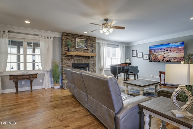 1486 Dry Creek Rd, Elizabethton, TN 37643 - living room featuring wood finished floors, baseboards, ceiling fan, a stone fireplace, and crown molding