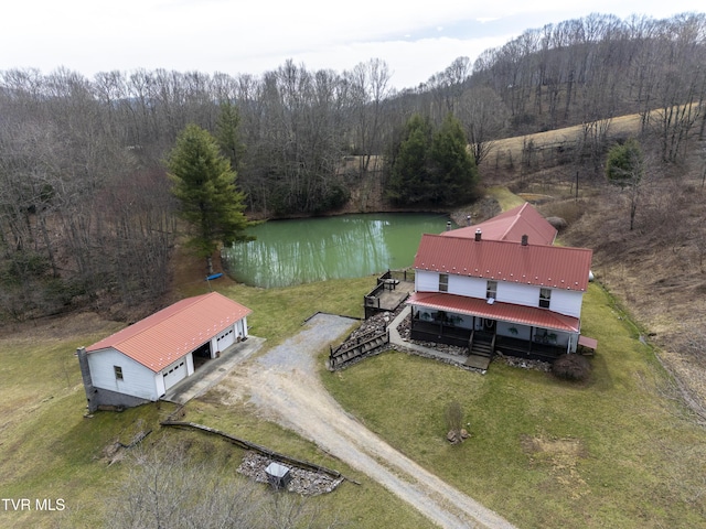 drone / aerial view featuring a view of trees and a water view