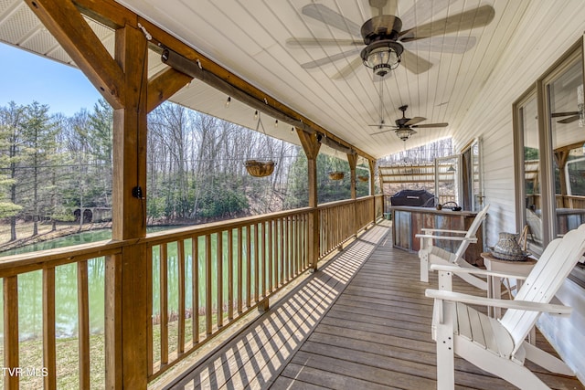 deck with a grill and a ceiling fan