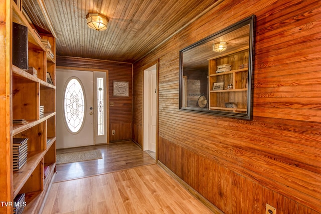 foyer entrance with wood ceiling and wood finished floors