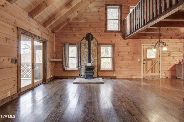 368 Ripshin Lake Rd, Roan Mountain, TN 37687 - unfurnished living room featuring hardwood / wood-style floors, plenty of natural light, wooden walls, beamed ceiling, and a wood stove
