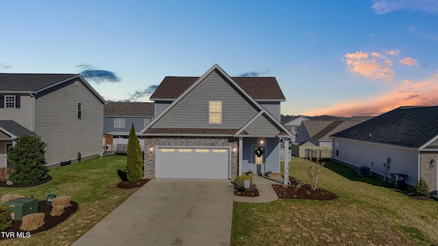 view of front of house with driveway, a front lawn, stone siding, central AC, and a garage