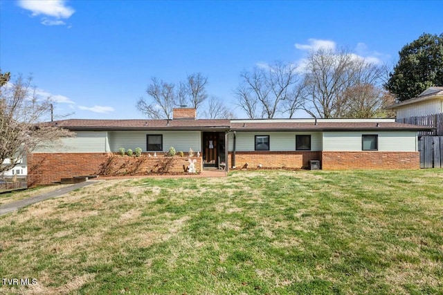 ranch-style home featuring a front yard, fence, brick siding, and a chimney