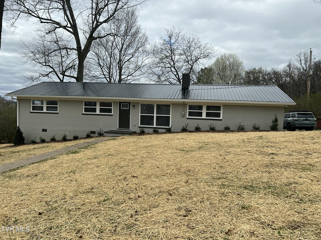 single story home with crawl space, a chimney, and metal roof