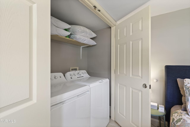 washroom with washing machine and dryer and laundry area