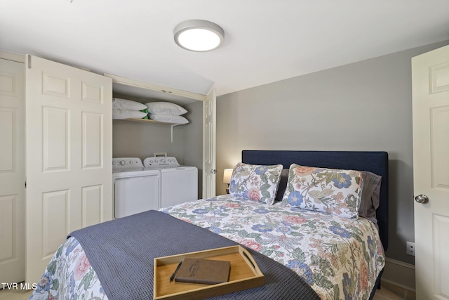 bedroom featuring washer and dryer and baseboards