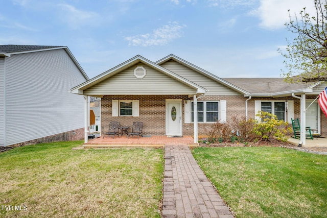 view of front facade with brick siding and a front lawn