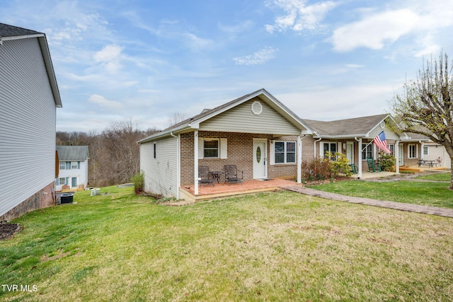 view of front of property with brick siding, central AC unit, and a front lawn