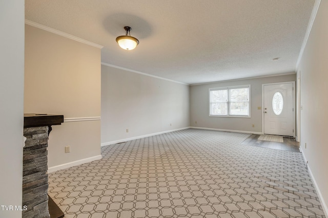 unfurnished living room featuring baseboards, a textured ceiling, and ornamental molding