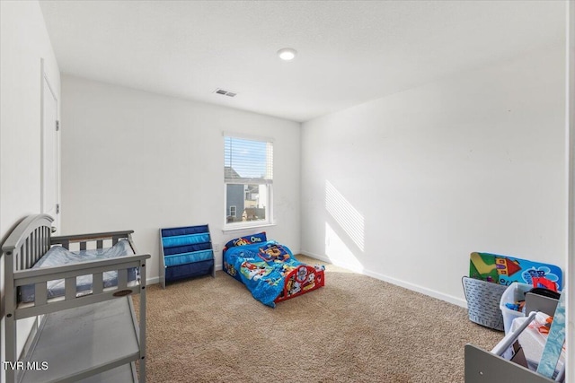 carpeted bedroom featuring visible vents and baseboards