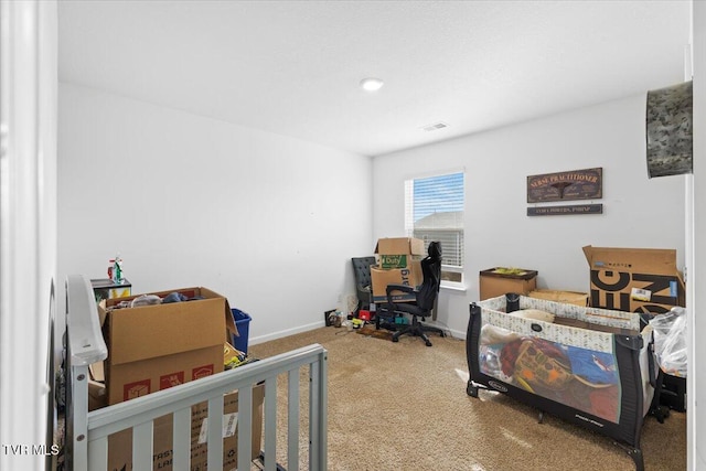carpeted bedroom featuring visible vents and baseboards