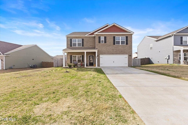 traditional home with driveway, a front yard, a garage, and fence