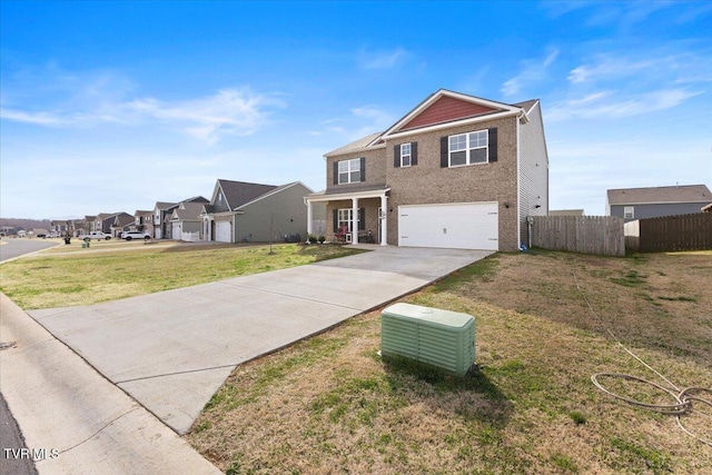 traditional-style home featuring a front yard, fence, concrete driveway, a garage, and a residential view