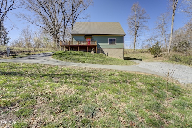 137 Unaka View Rd, Johnson City, TN 37601 - view of front of house with a deck, driveway, metal roof, and a front lawn