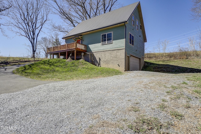 137 Unaka View Rd, Johnson City, TN 37601 - view of front of house featuring a deck, metal roof, gravel driveway, and a garage