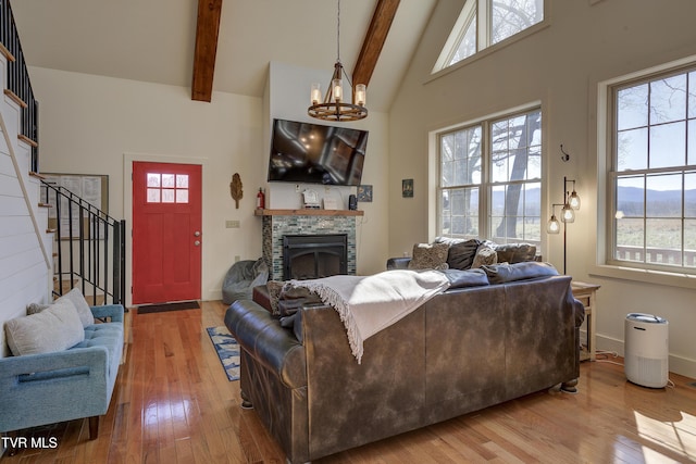 137 Unaka View Rd, Johnson City, TN 37601 - living room with beam ceiling, plenty of natural light, an inviting chandelier, and wood-type flooring
