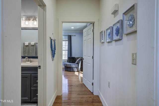137 Unaka View Rd, Johnson City, TN 37601 - hallway featuring dark wood-style floors, crown molding, baseboards, and a sink