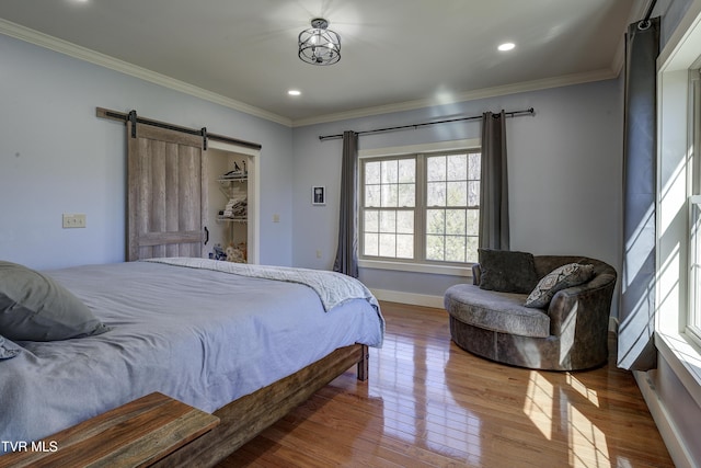 137 Unaka View Rd, Johnson City, TN 37601 - bedroom with a barn door, crown molding, and wood finished floors