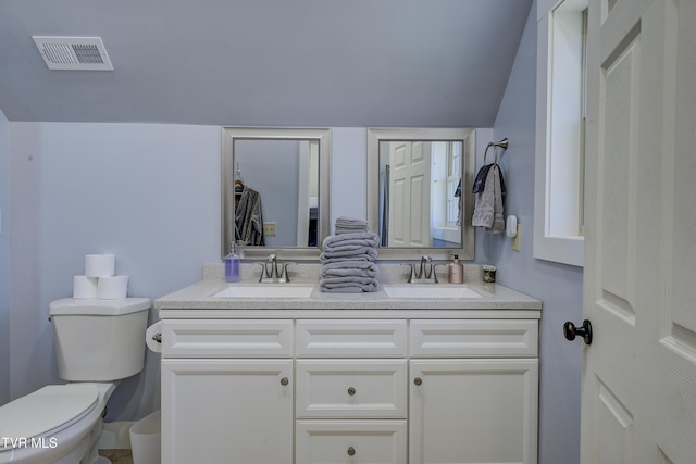 137 Unaka View Rd, Johnson City, TN 37601 - bathroom featuring double vanity, toilet, visible vents, and a sink