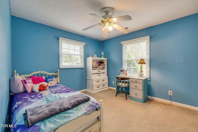 bedroom featuring ceiling fan, light carpet, baseboards, and multiple windows
