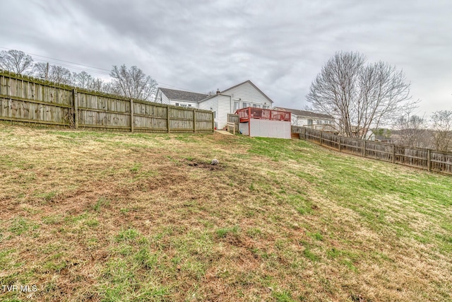 view of yard featuring a wooden deck and a fenced backyard