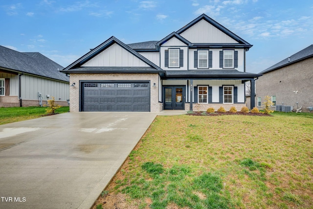 view of front facade featuring an attached garage, board and batten siding, a front lawn, central AC unit, and driveway