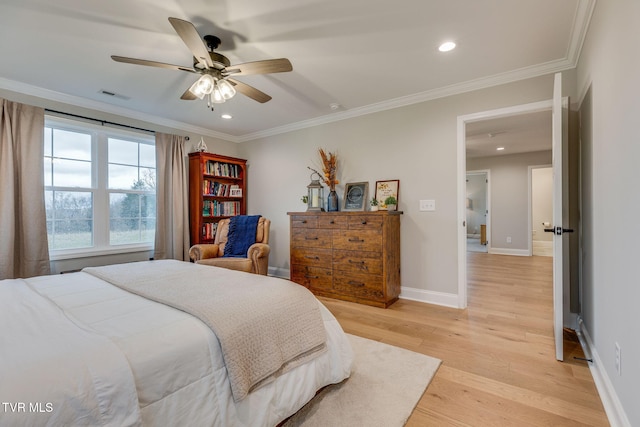 bedroom with visible vents, baseboards, ornamental molding, and light wood finished floors