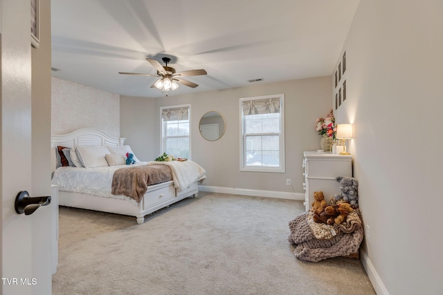 carpeted bedroom featuring baseboards, visible vents, and ceiling fan
