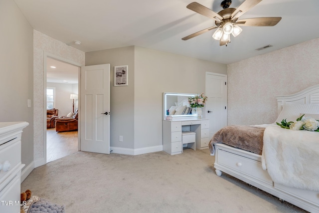 carpeted bedroom featuring baseboards, visible vents, and ceiling fan