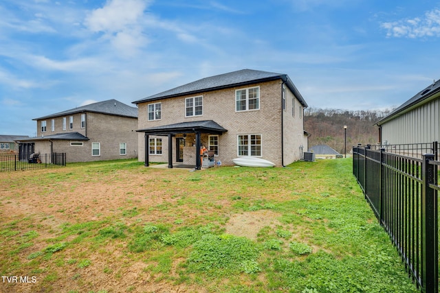 back of house with a lawn, a patio, fence, cooling unit, and brick siding