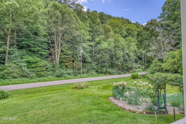 exterior space featuring a wooded view