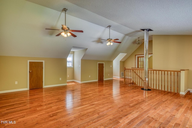 bonus room featuring ceiling fan, vaulted ceiling, baseboards, and light wood-type flooring